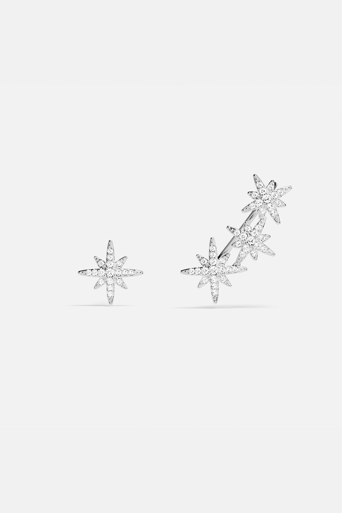 Earrings APM Monaco, silver-tone asymmetric triple meteorite cubic zirconia earrings.