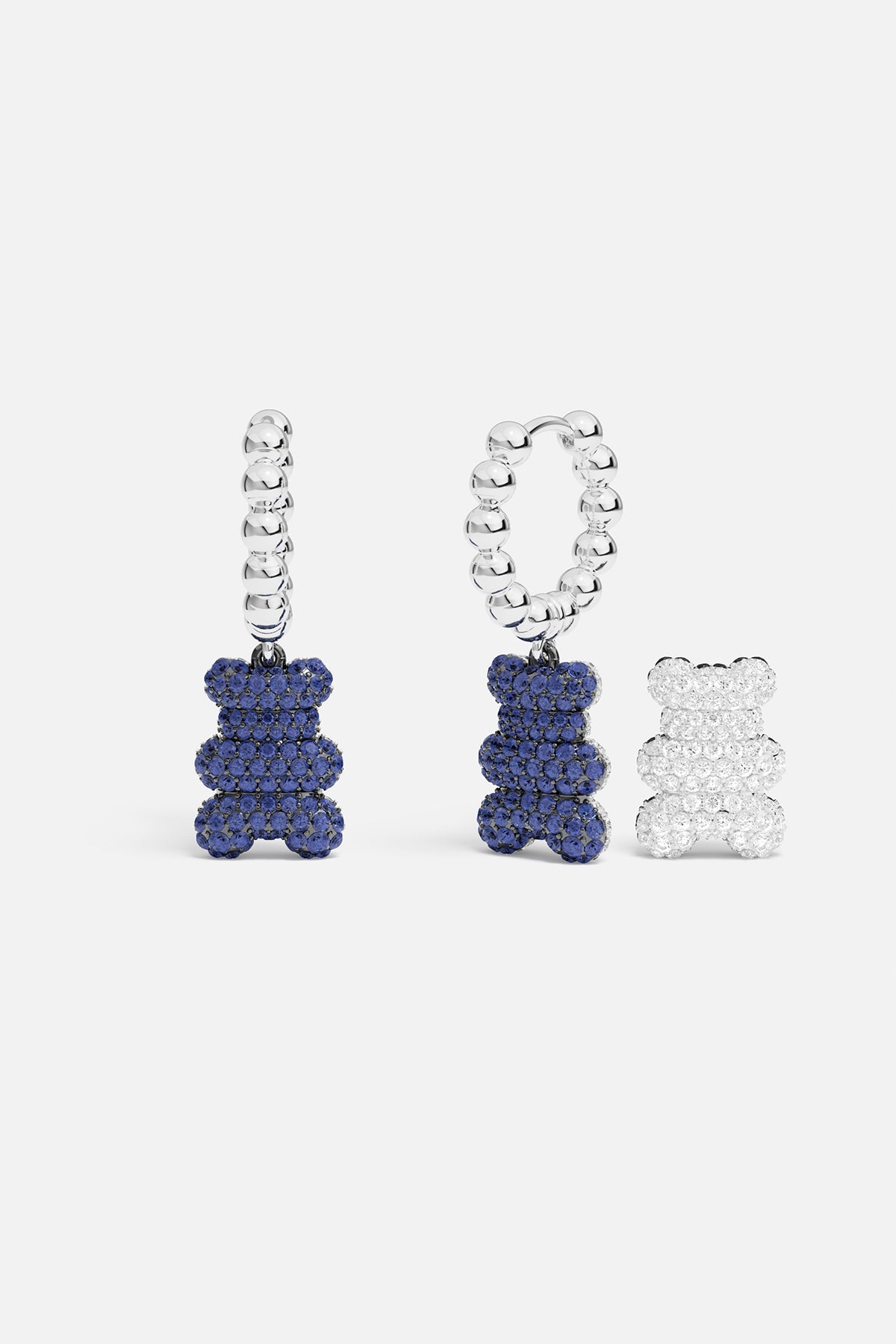 Blue teddy bear pavé beaded hoop earrings with white teddy bear pavé pendant against a white background