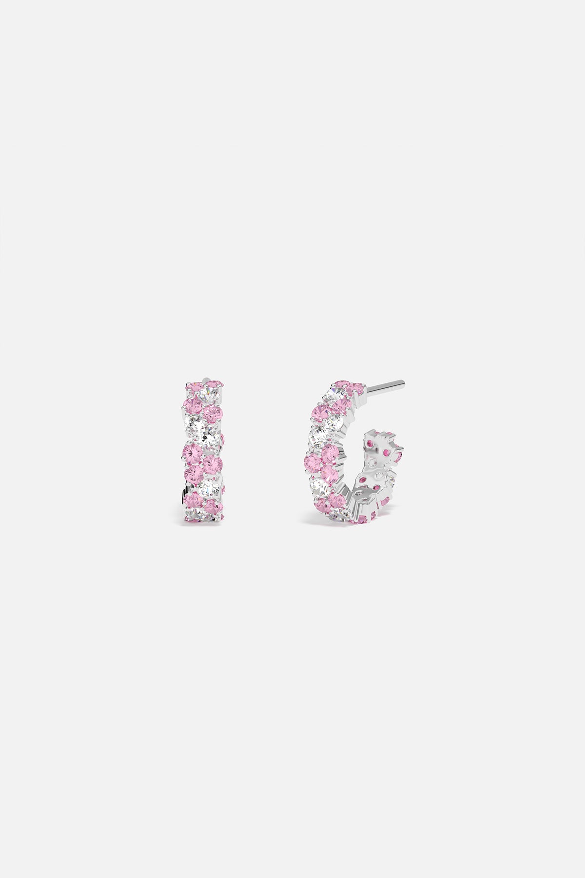 Pair of sterling silver hoop earrings with pastel pink pavé accents on a white background