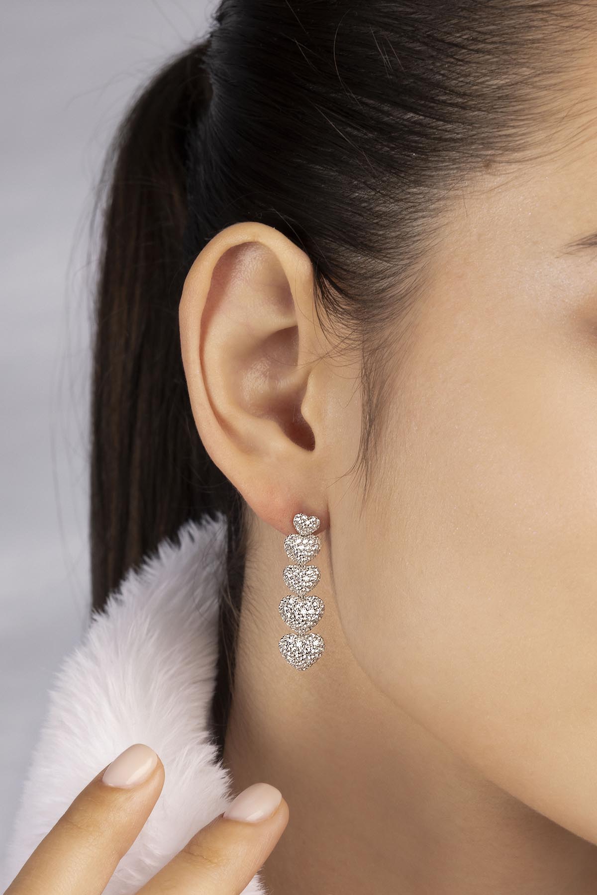 APM MONACO heart drop earring in silver worn on model