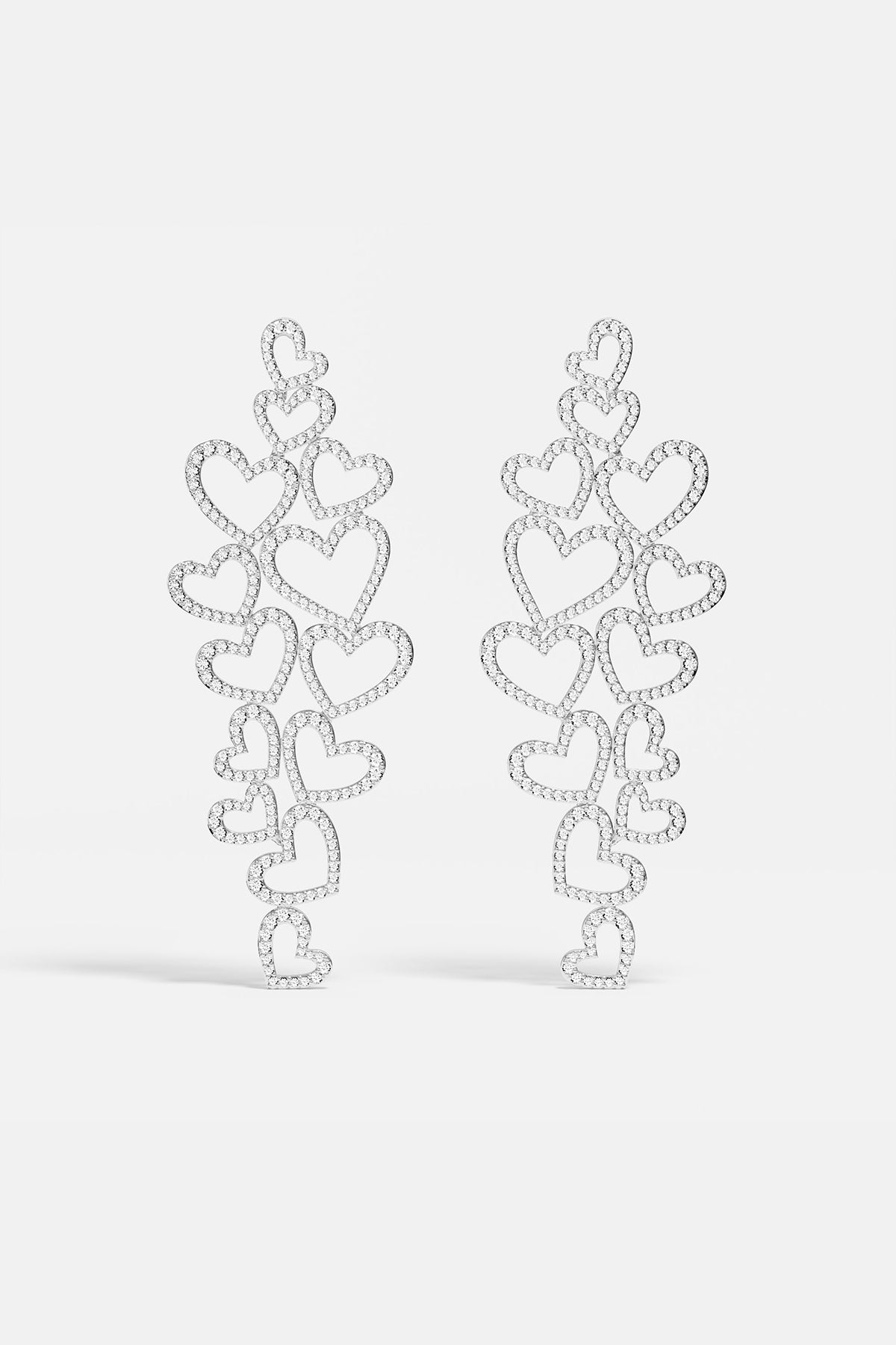 Statement APM MONACO silver heart-shaped earrings on a white background