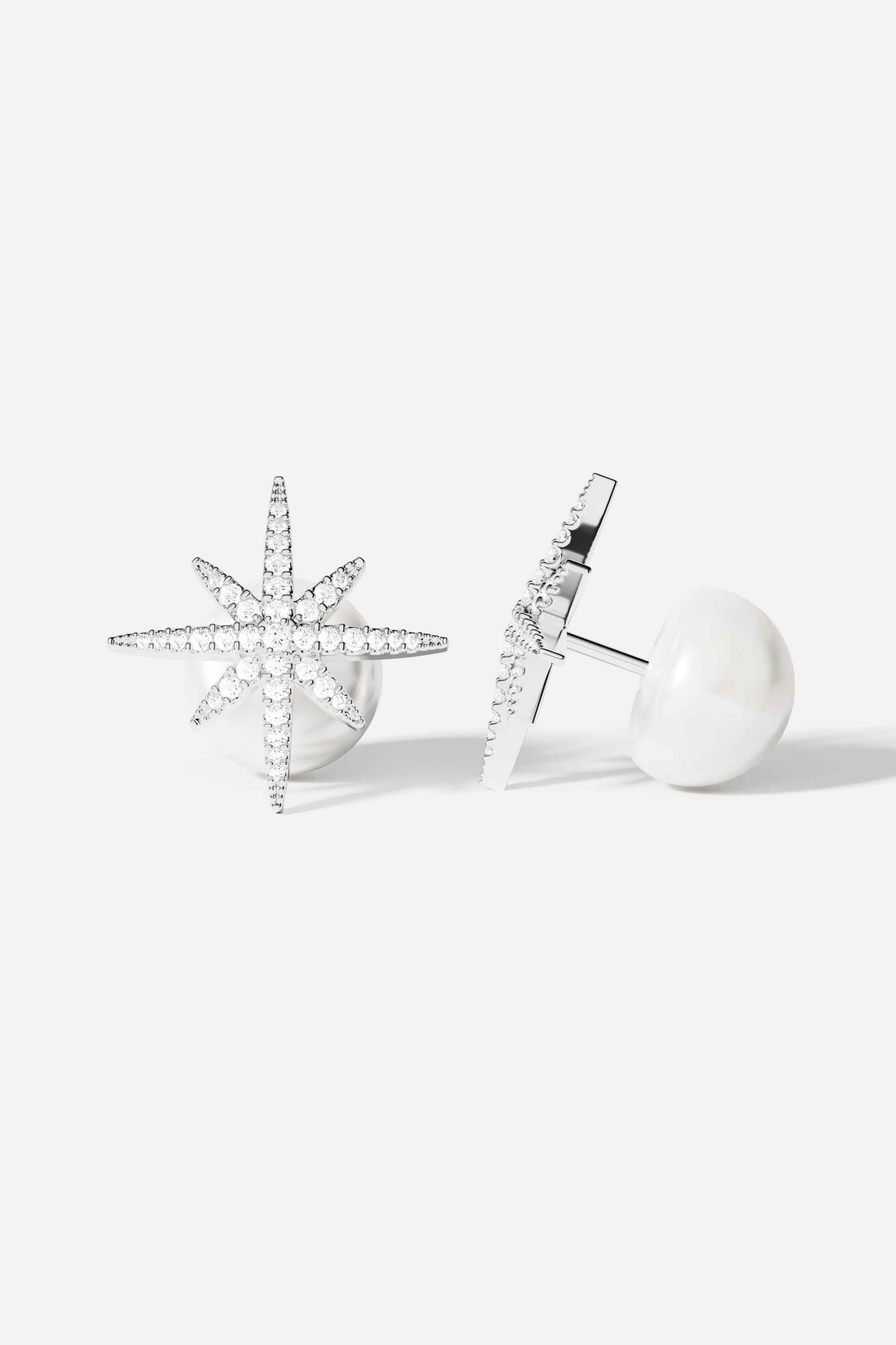 Earrings APM Monaco starburst meteorite-inspired stud with a white pearl, white metal finish.