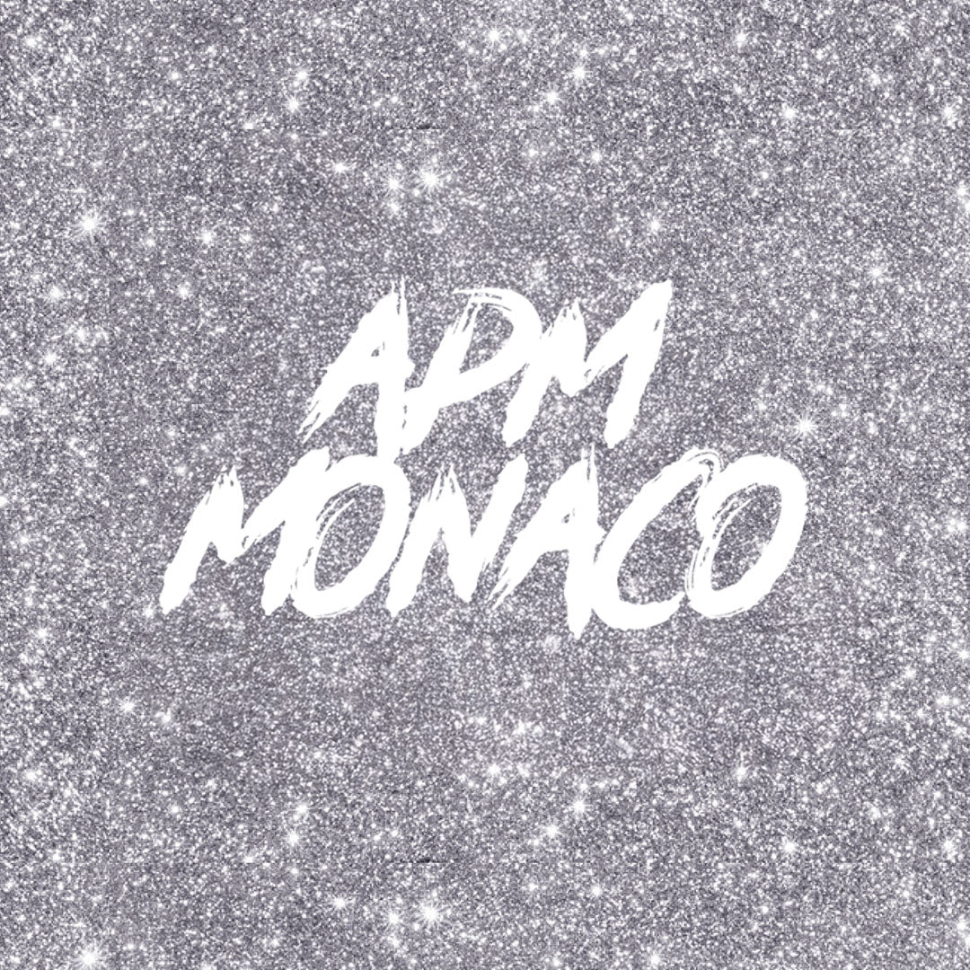 'APM Monaco' gift card on a glittery silver background