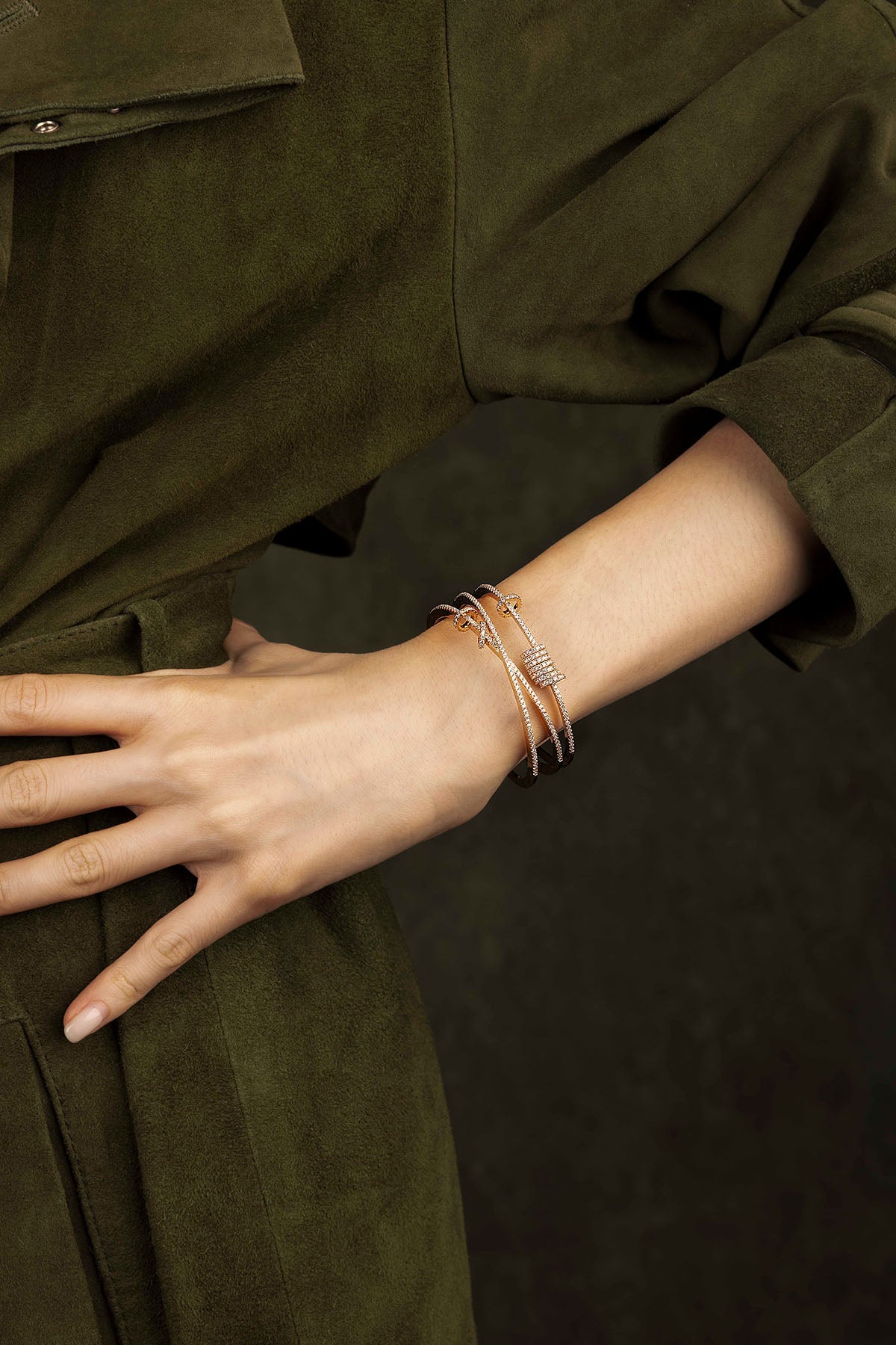 Close-up of a wrist wearing multiple bracelets on a dark background