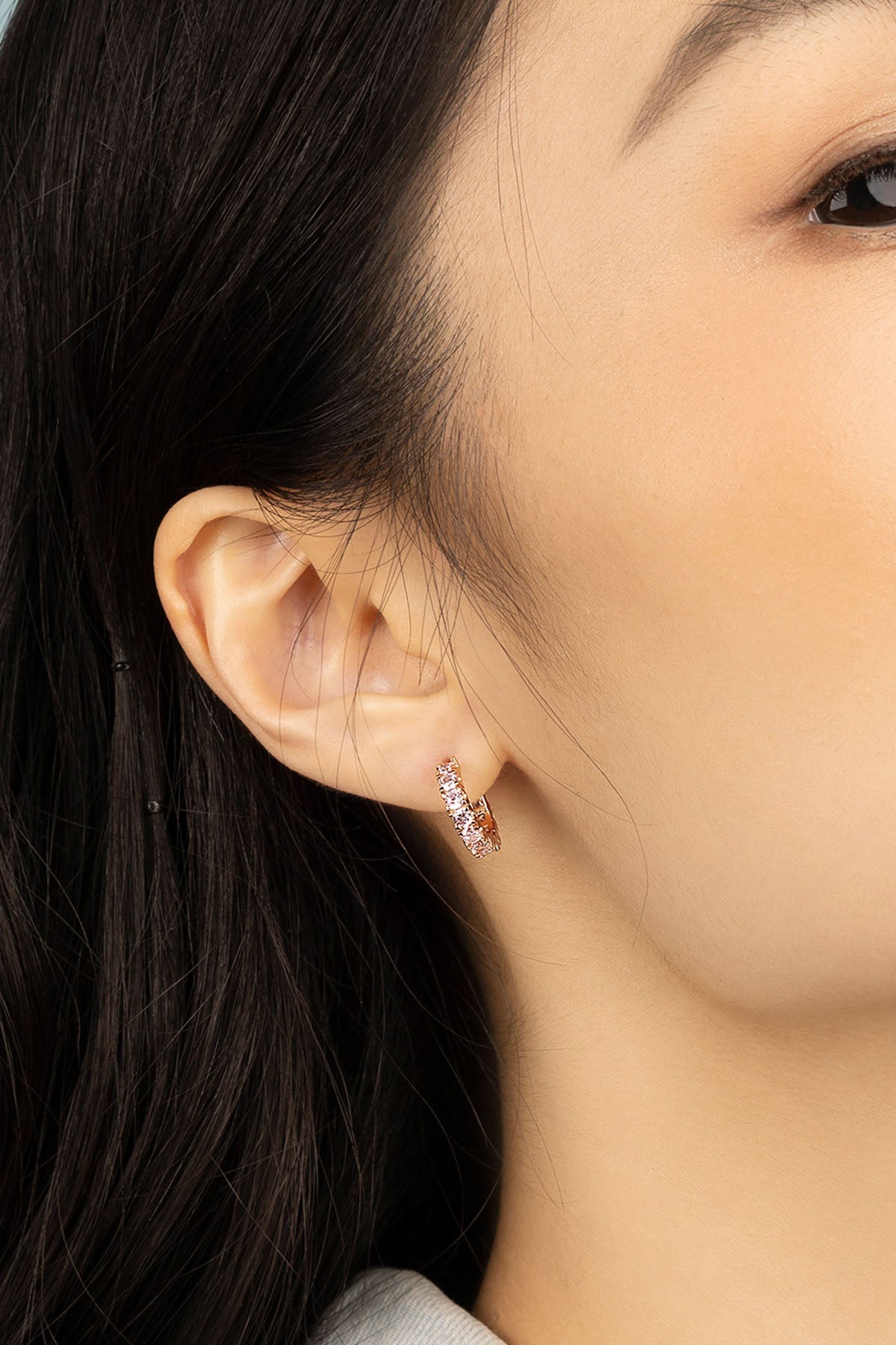 APM Monaco Pavé Huggie Earrings in Rose gold worn on ear