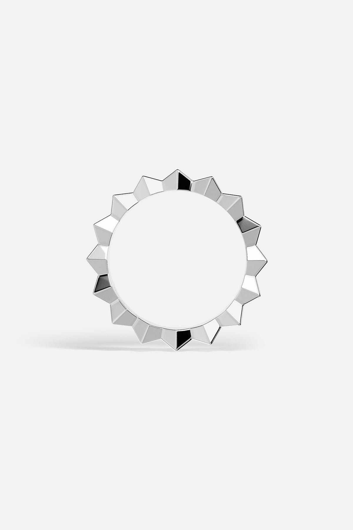 Silver-tone ring with geometric design on a white background