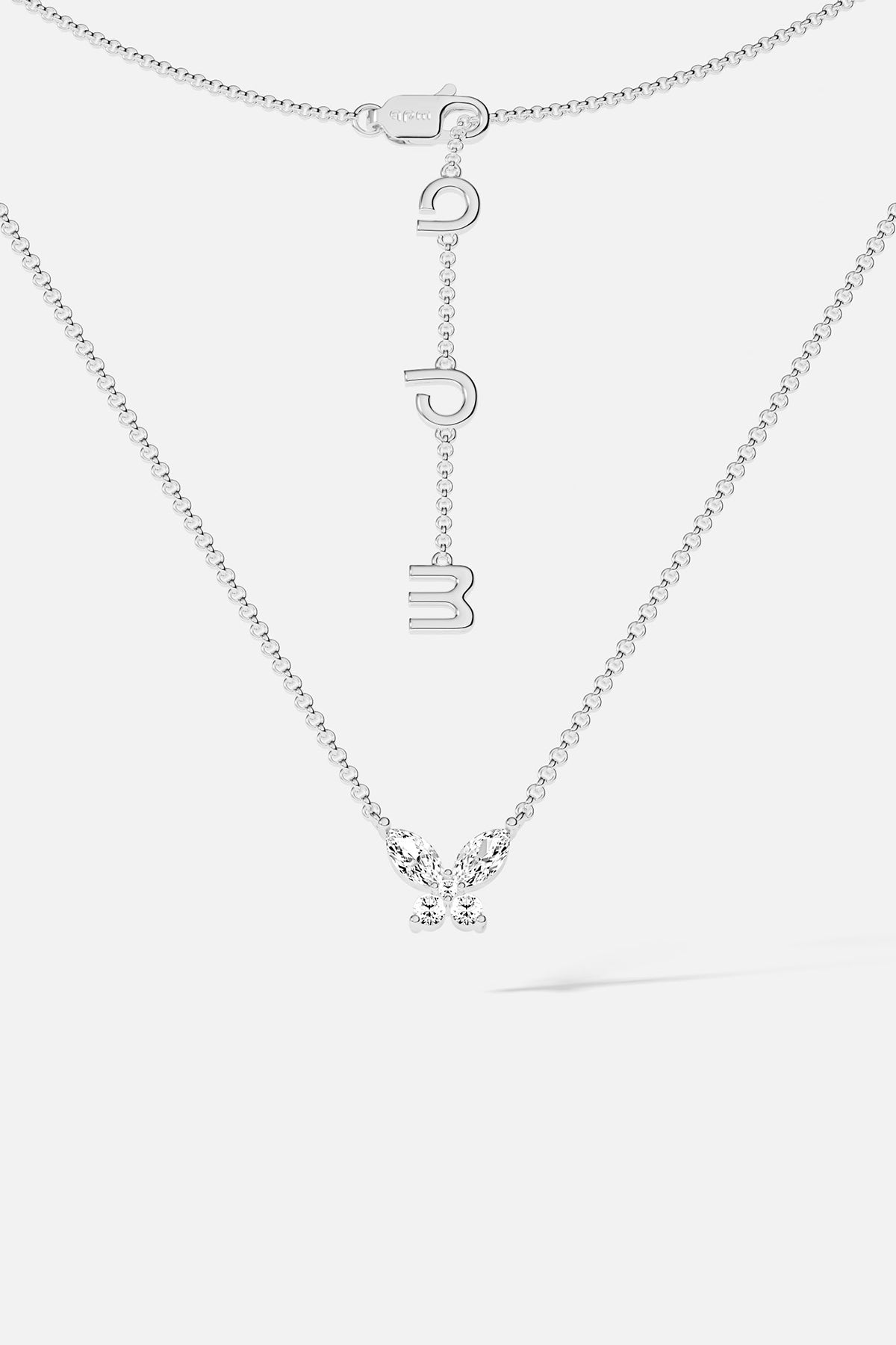 Necklaces APM Monaco. White gold butterfly necklace with white cubic zirconia on a Silver-tone chain; butterfly pendant and APM clasp.