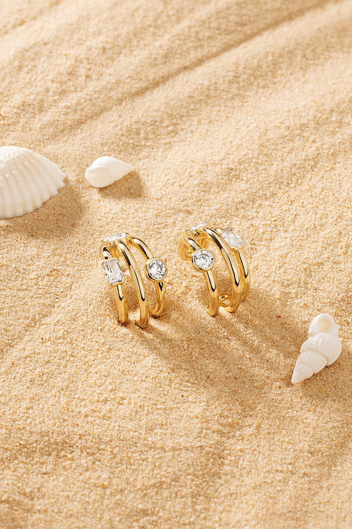 APM Monaco Triple Éclat Earrings on soft beach